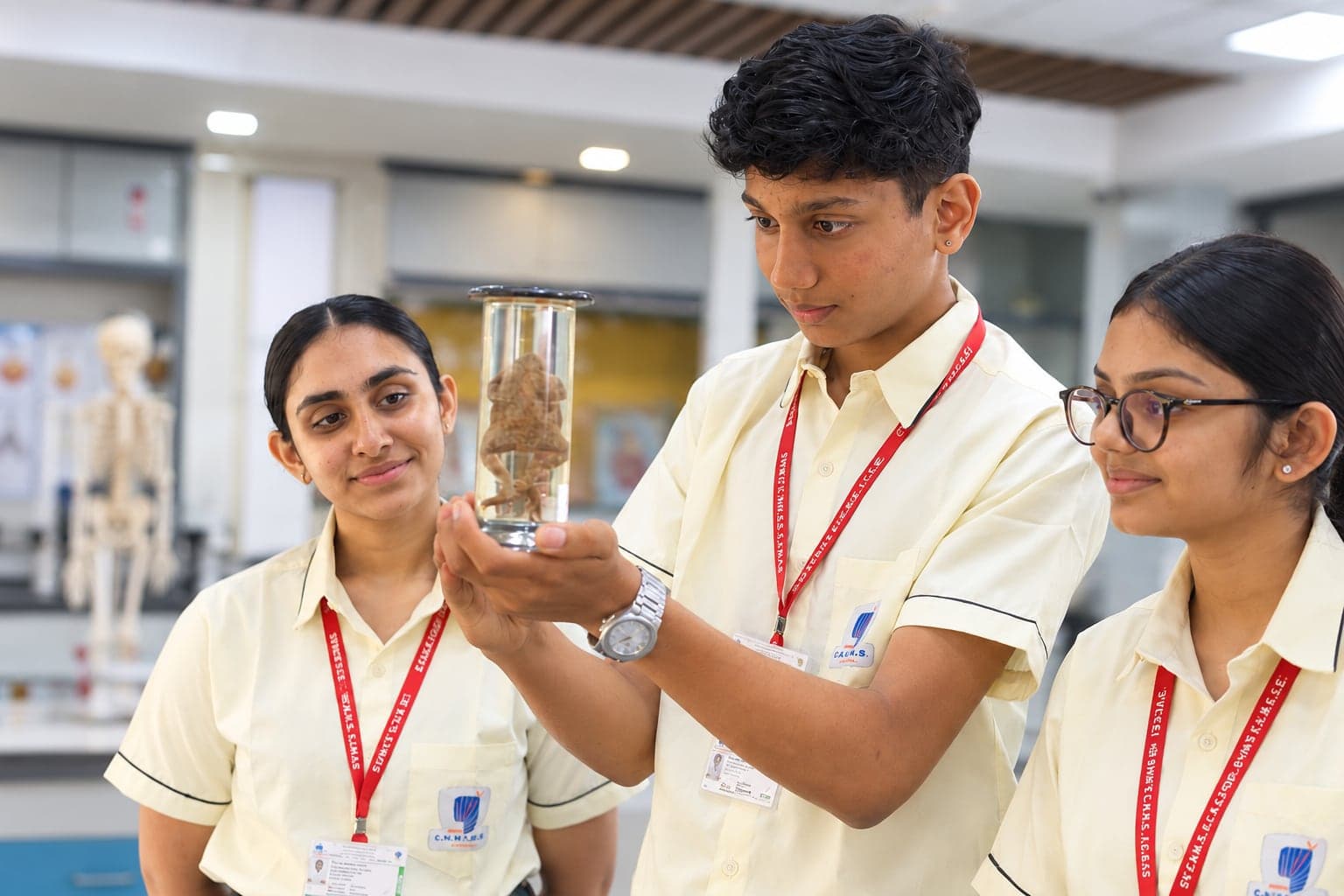 Students and a teacher looking at a specimen in the science lab