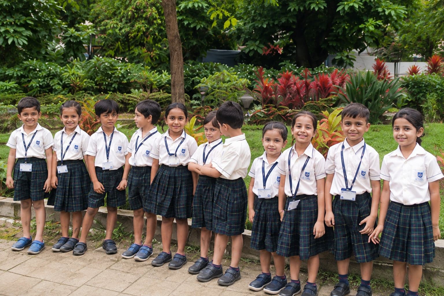 A line of young students in a garden