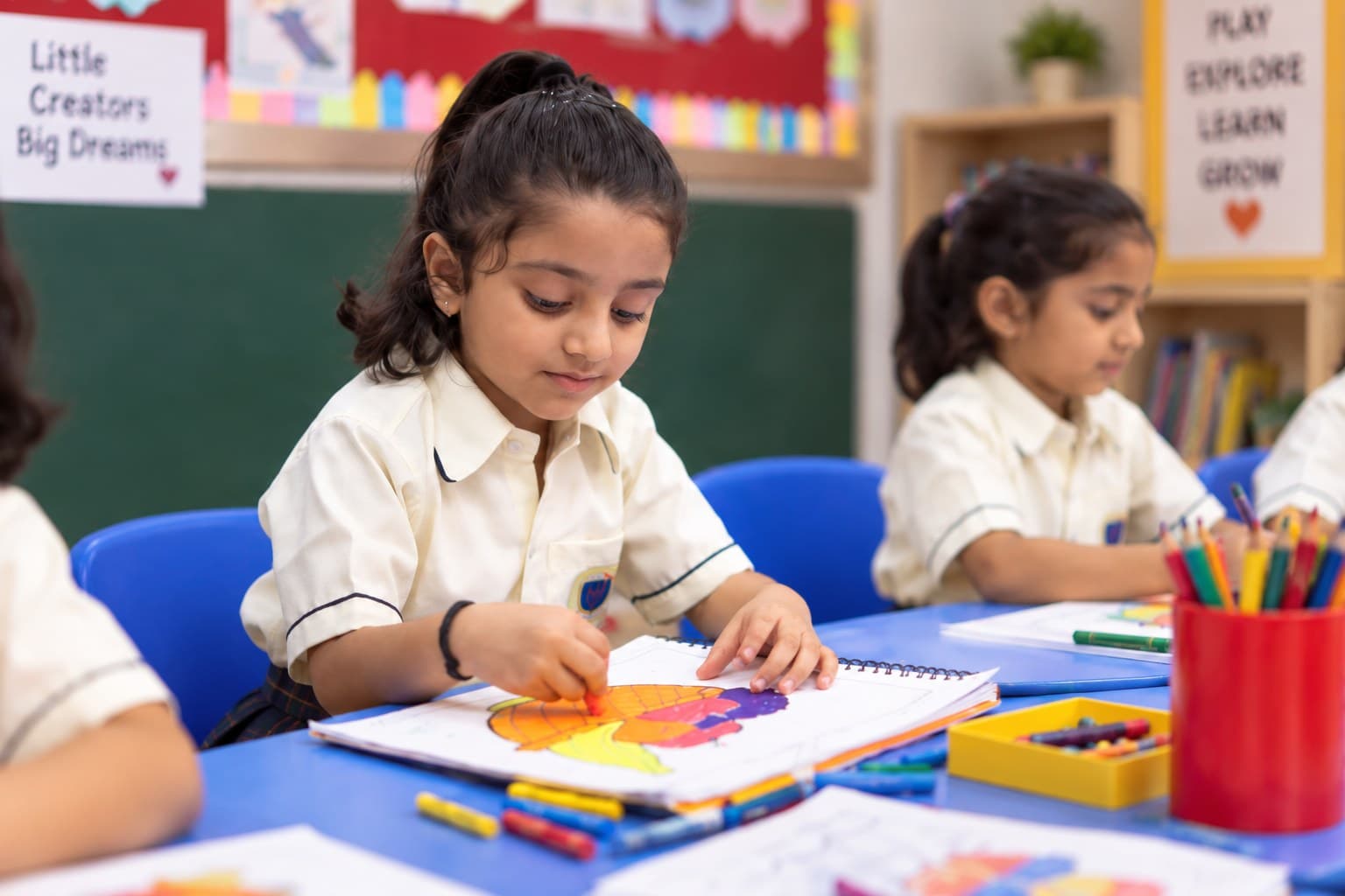 A primary student colouring in a notebook
