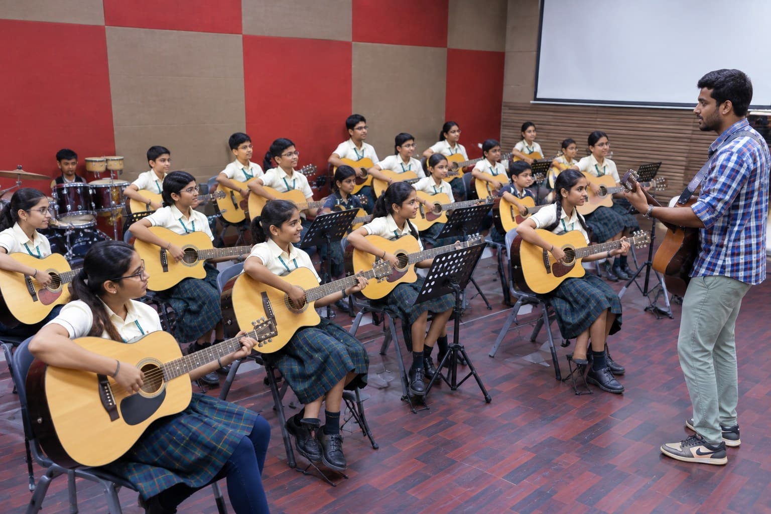 Students playing guitars in music class