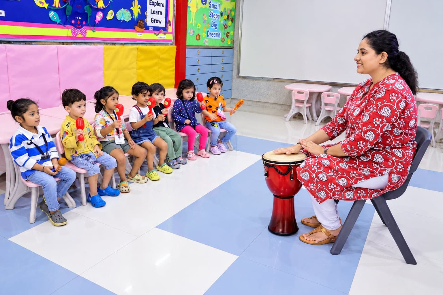 A teacher with Pre-Primary children sitting in a circle
