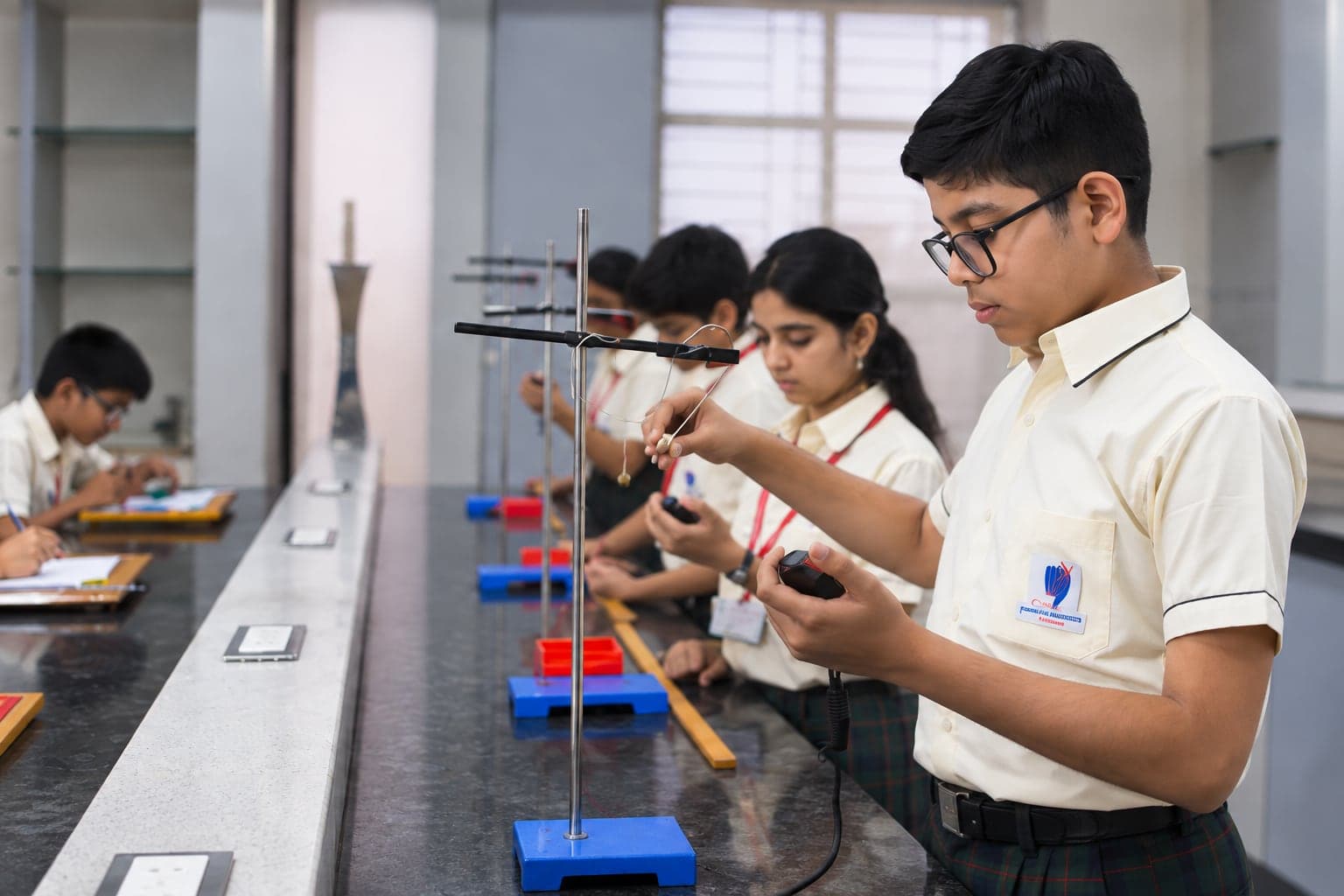 Secondary students carrying out a physics experiment