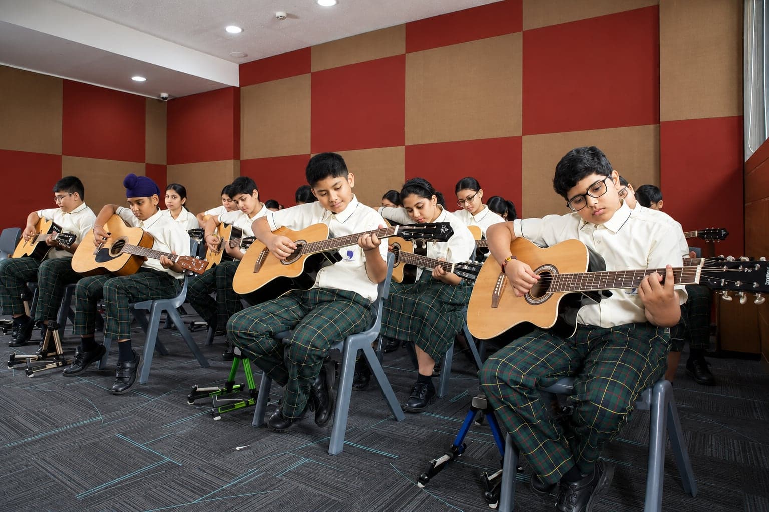 Students playing guitars in a music class