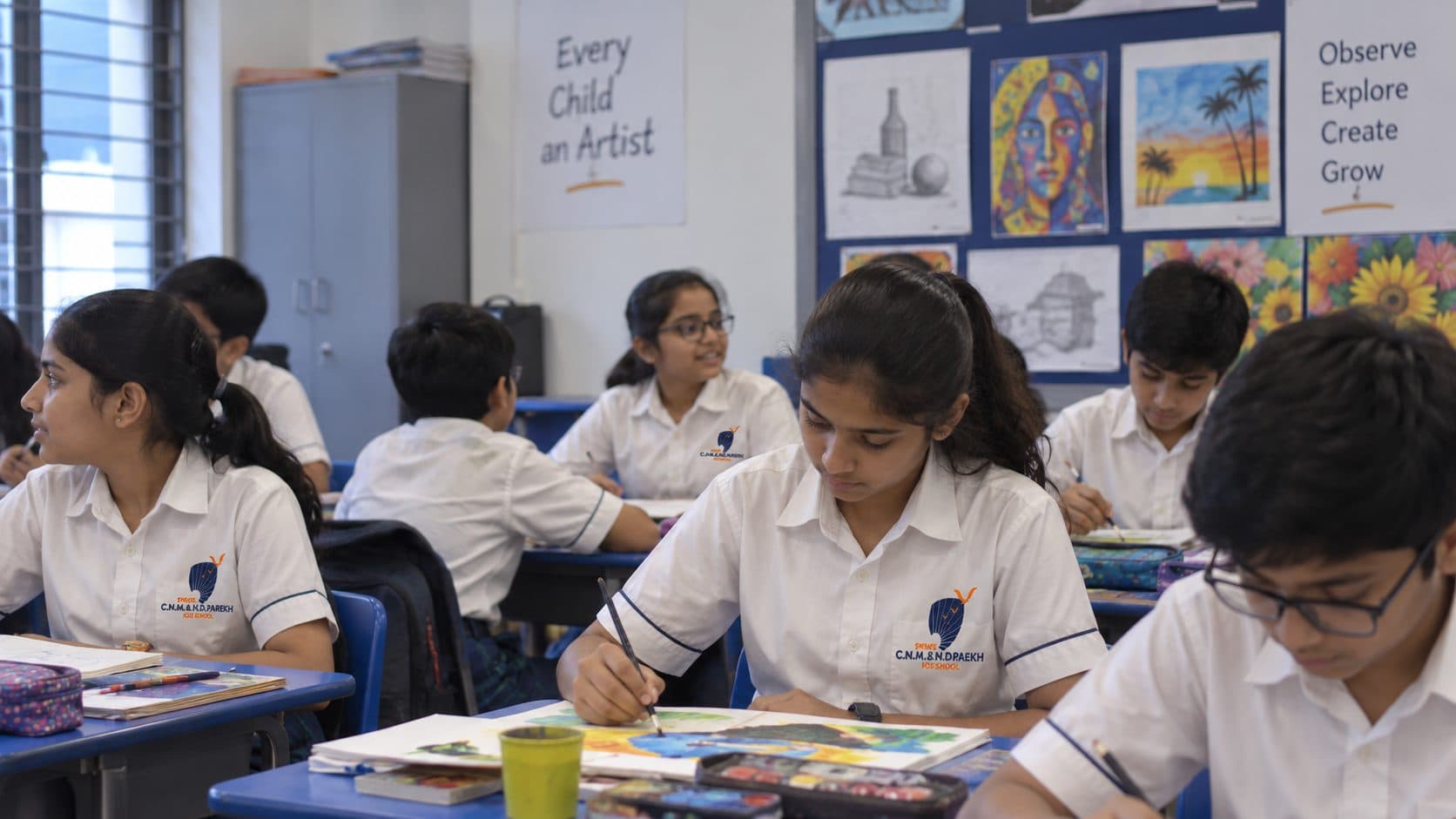 Students painting and sculpting clay in an art class