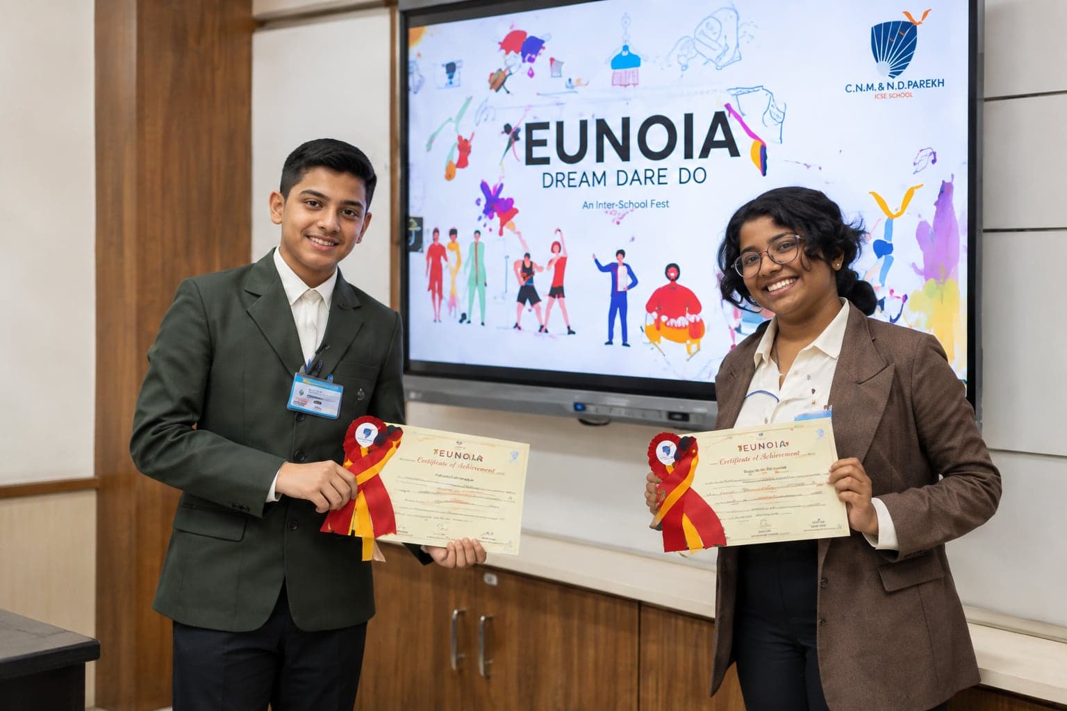 Two students with Eunoia certificates